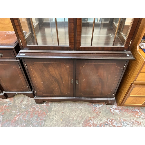 53 - A Georgian style mahogany display cabinet with two glazed doors, four glass shelves and two lower cu... 