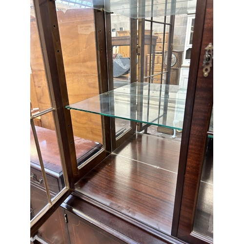 53 - A Georgian style mahogany display cabinet with two glazed doors, four glass shelves and two lower cu... 