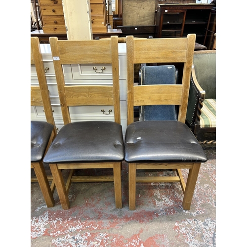 63 - Four modern solid oak and brown leatherette dining chairs