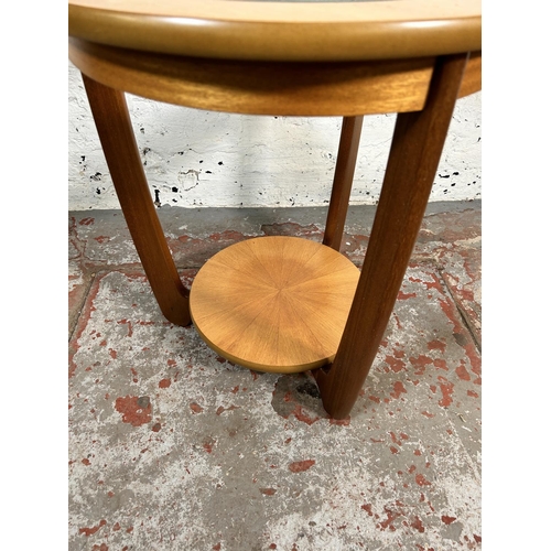 79 - A Nathan teak and glass circular two tier side table - approx. 55cm high x 50cm diameter