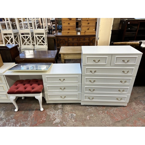 83 - A white laminate two piece bedroom suite comprising dressing table and chest of drawers