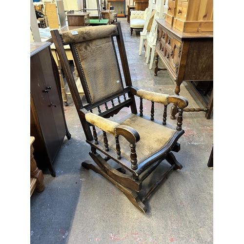 92 - An early 20th century American beech and brown fabric upholstered rocking chair