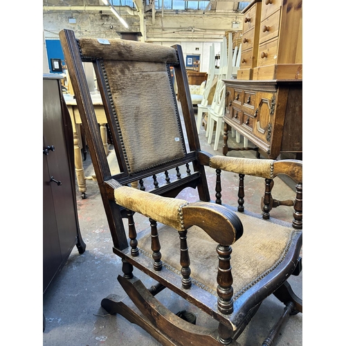 92 - An early 20th century American beech and brown fabric upholstered rocking chair