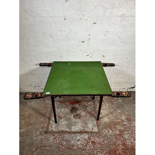 97 - An early 20th century wooden folding card table with green baize top - approx. 69cm high x 76cm wide... 