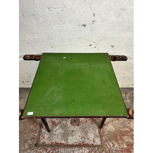 97 - An early 20th century wooden folding card table with green baize top - approx. 69cm high x 76cm wide... 