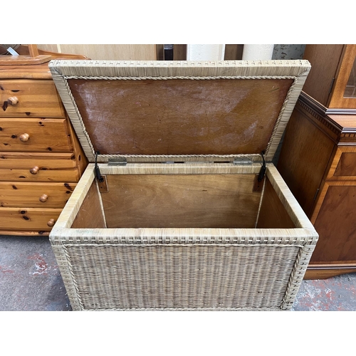 183 - A wicker blanket box with black metal handles - approx. 53cm high x 92cm wide x 52cm deep