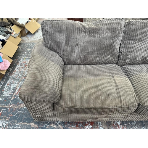 192 - A modern grey fabric upholstered three seater sofa - approx. 83cm high x 210cm wide x 94cm deep