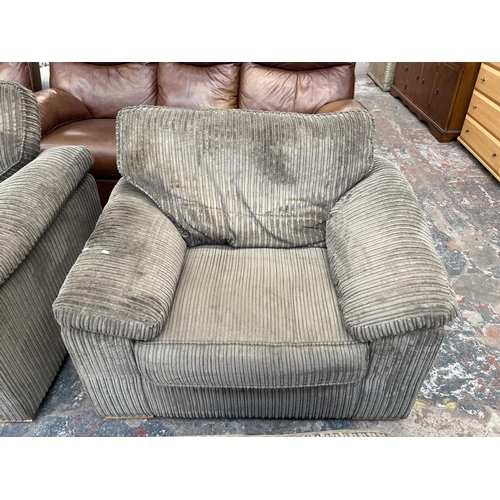 193 - A modern grey fabric upholstered four piece lounge suite comprising three seater sofa, armchair and ... 