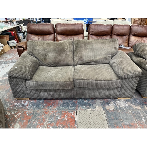 193 - A modern grey fabric upholstered four piece lounge suite comprising three seater sofa, armchair and ... 