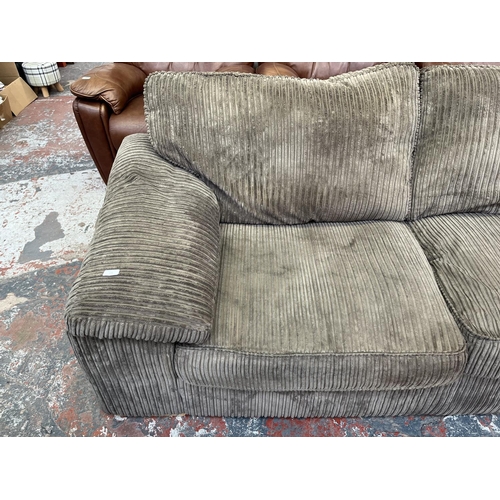 193 - A modern grey fabric upholstered four piece lounge suite comprising three seater sofa, armchair and ... 