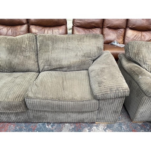 193 - A modern grey fabric upholstered four piece lounge suite comprising three seater sofa, armchair and ... 