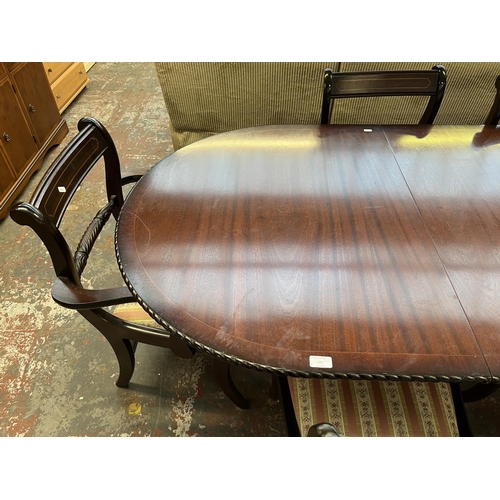 197 - A mahogany twin pedestal extending dining table and six chairs - approx. 77cm high x 93cm wide x 200... 