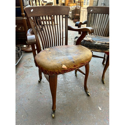 56 - A pair of Edwardian oak desk chairs - approx. 92cm high x 63cm wide x 50cm deep