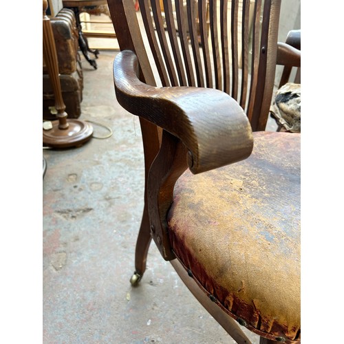 56 - A pair of Edwardian oak desk chairs - approx. 92cm high x 63cm wide x 50cm deep