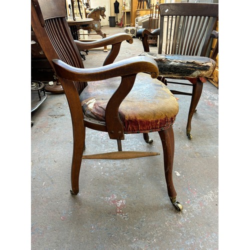 56 - A pair of Edwardian oak desk chairs - approx. 92cm high x 63cm wide x 50cm deep