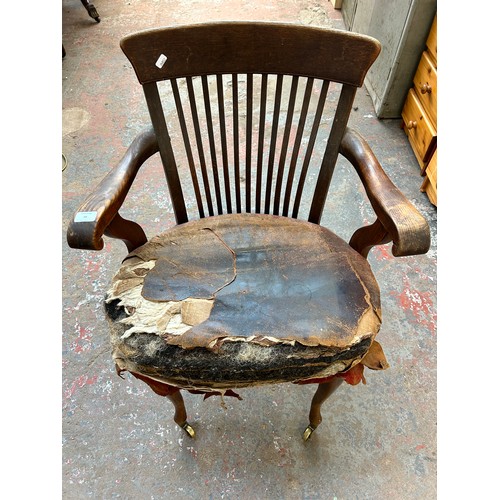 56 - A pair of Edwardian oak desk chairs - approx. 92cm high x 63cm wide x 50cm deep