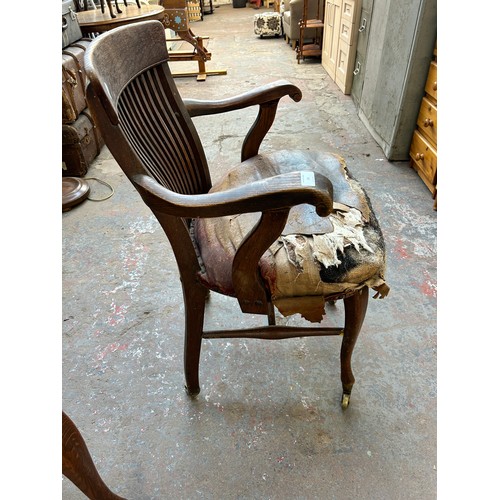 56 - A pair of Edwardian oak desk chairs - approx. 92cm high x 63cm wide x 50cm deep