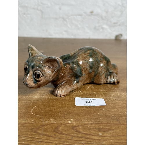 241 - A Brannam Barnstaple pottery mottled glazed cat figurine, signed to base - approx. 21cm long