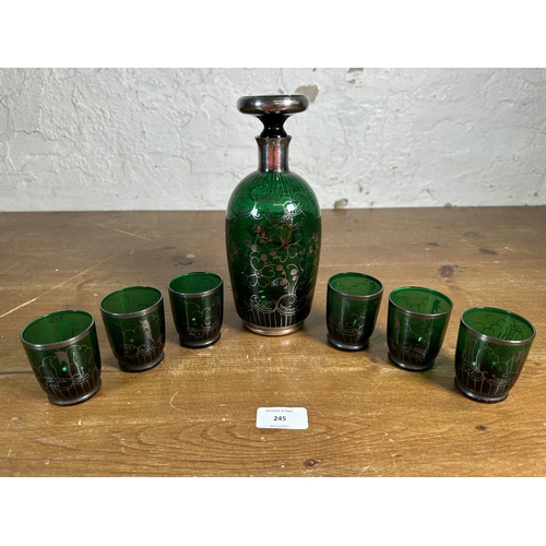 245 - A mid 20th century green glass and silver overlay seven piece drinking set