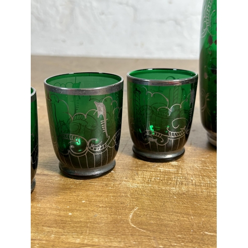 245 - A mid 20th century green glass and silver overlay seven piece drinking set