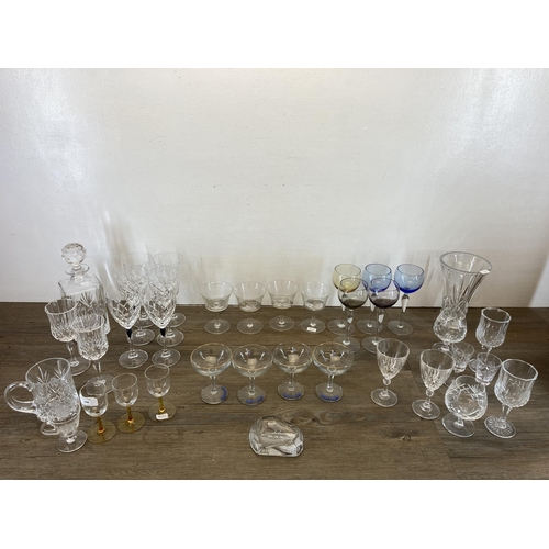 298 - A collection of glassware to include Edinburgh Crystal cut glass decanter, clear and blue cut glass ... 