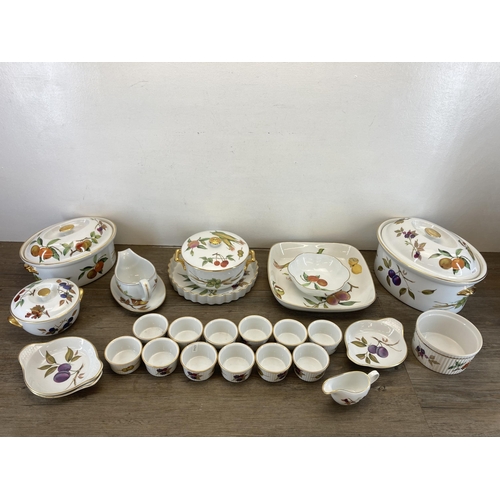 317 - A collection of Royal Worcester Evesham china to include four lidded tureens, ramekins etc.