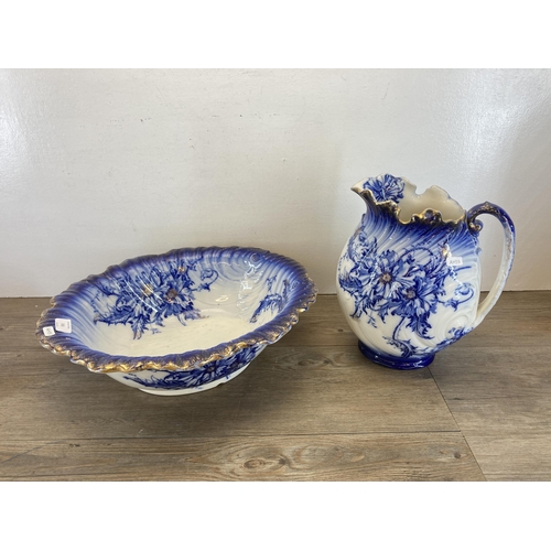 318 - Four pieces of late 19th century Nautilus pottery to include water jug and wash bowl etc.