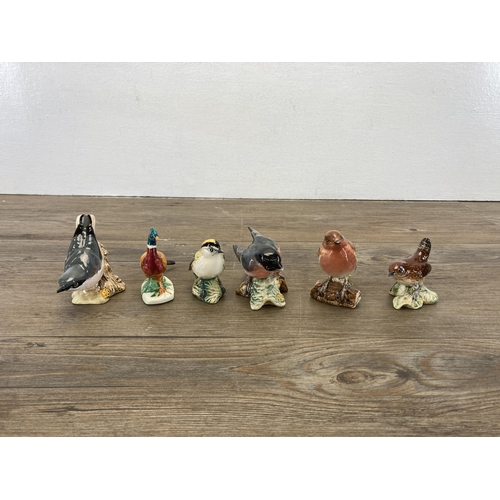 326 - A collection of animal figurines to include seven Beswick, two carved hardwood elephants etc.