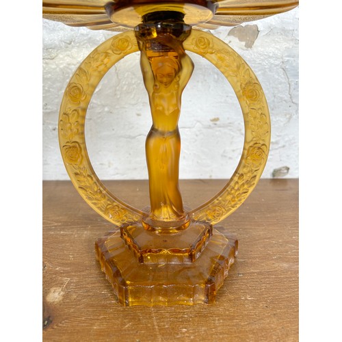 275 - An Art Deco style amber glass figural centerpiece pedestal bowl - approx. 27cm high x 25cm in diamet... 