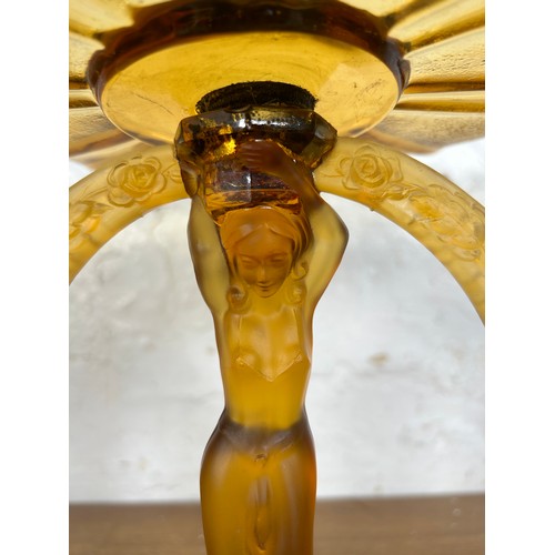 275 - An Art Deco style amber glass figural centerpiece pedestal bowl - approx. 27cm high x 25cm in diamet... 