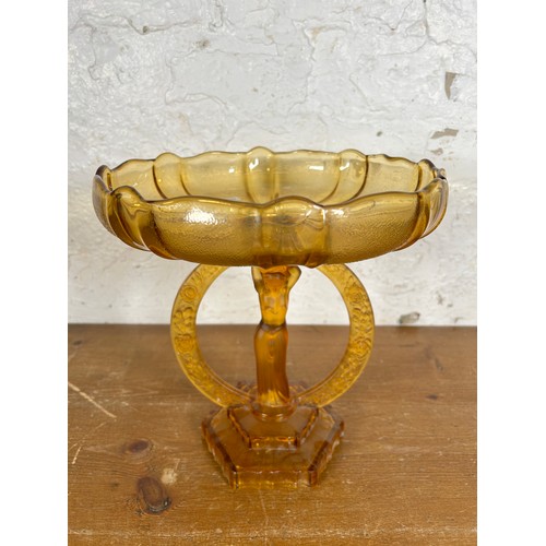 275 - An Art Deco style amber glass figural centerpiece pedestal bowl - approx. 27cm high x 25cm in diamet... 