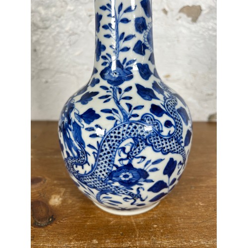 279 - A Chinese blue and white dragon and foliate design porcelain vase with elongated flared neck, ovoid ... 