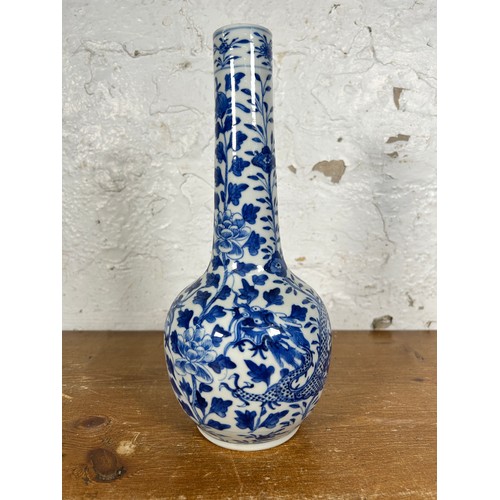 279 - A Chinese blue and white dragon and foliate design porcelain vase with elongated flared neck, ovoid ... 