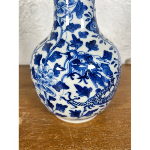 279 - A Chinese blue and white dragon and foliate design porcelain vase with elongated flared neck, ovoid ... 