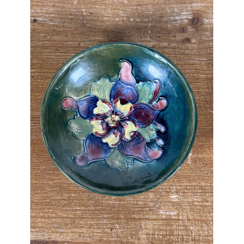 268 - A Moorcroft pottery Columbine pattern circular footed dish - approx. 3.5cm high x 10.5cm in diameter