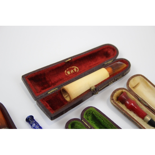 2340 - A collection of cheroot holders to include meerschaum, amber glass etc.