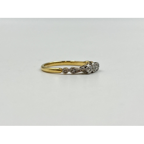 2151 - An 18ct gold and platinum diamond trilogy ring with diamond shoulders - approx. gross weight 3g