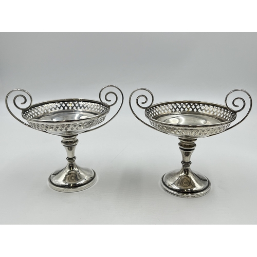 2283 - A pair of Edwardian Walker & Hall hallmarked Sheffield silver pierced twin handled pedestal dishes, ... 