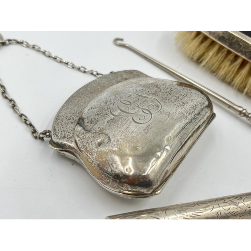 2298 - Four hallmarked sterling silver vanity items to include brush, purse etc. - approx. gross weight 133... 