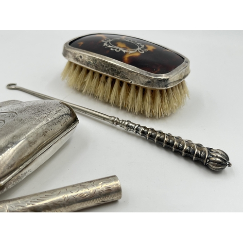 2298 - Four hallmarked sterling silver vanity items to include brush, purse etc. - approx. gross weight 133... 