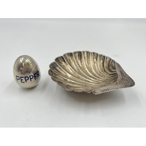 2303 - Two pieces of hallmarked sterling silver, one scallop dish and one pepper pot - approx. gross weight... 