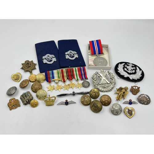 2352 - A collection of medals, buttons, cap and pin badges to include RAF, Royal Navy, 1939-1945 War medal,... 