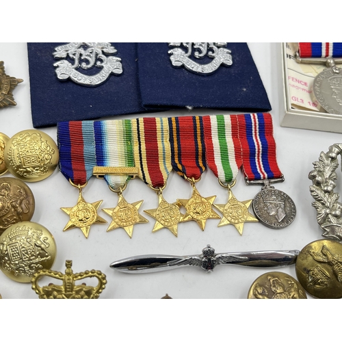 2352 - A collection of medals, buttons, cap and pin badges to include RAF, Royal Navy, 1939-1945 War medal,... 