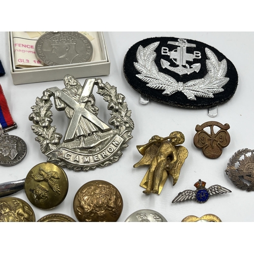 2352 - A collection of medals, buttons, cap and pin badges to include RAF, Royal Navy, 1939-1945 War medal,... 