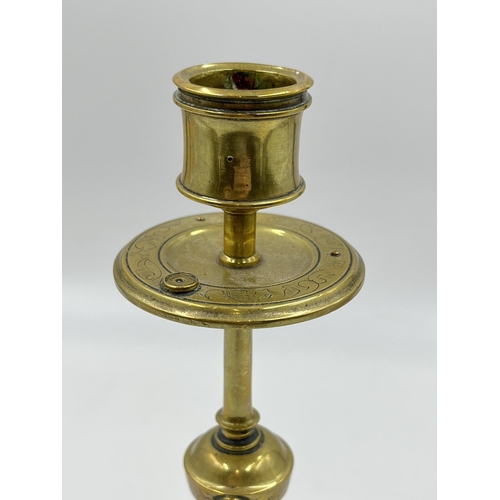 2354 - An Arts and Crafts etched brass candlestick with blue cabochon stone - approx. 20cm high