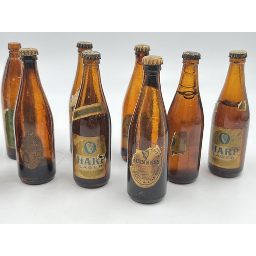 2360 - A collection of vintage miniature glass beer bottles together with Guinness bottle opener