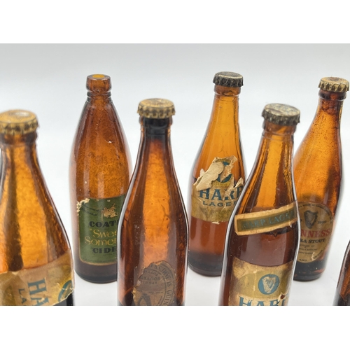 2360 - A collection of vintage miniature glass beer bottles together with Guinness bottle opener