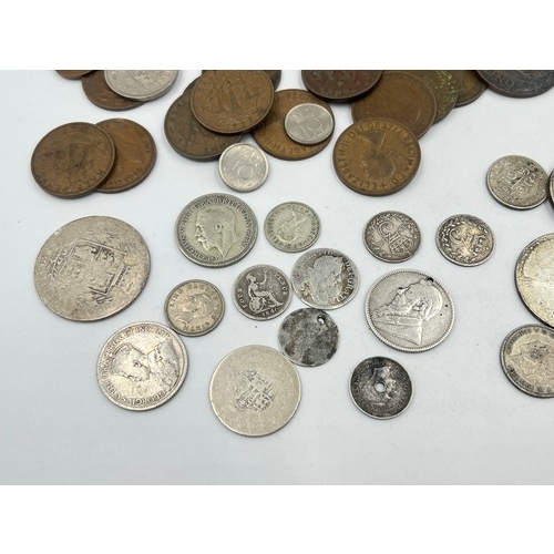 2369 - A collection of world coins with silver examples to include 92.5% South African shilling, 92.5% silv... 