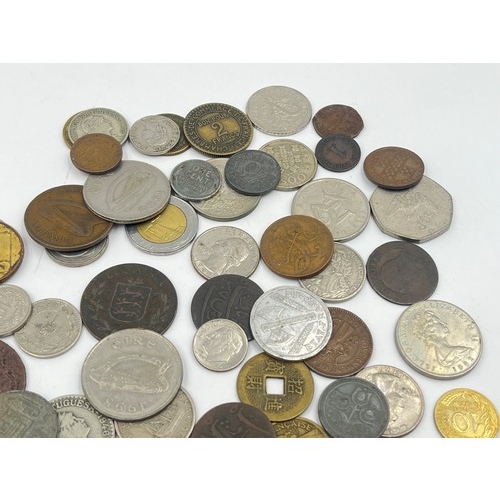 2370 - A collection of world coins to include 40% silver 1968 'Kennedy' dollar, 50% silver 1934 New Zealand... 