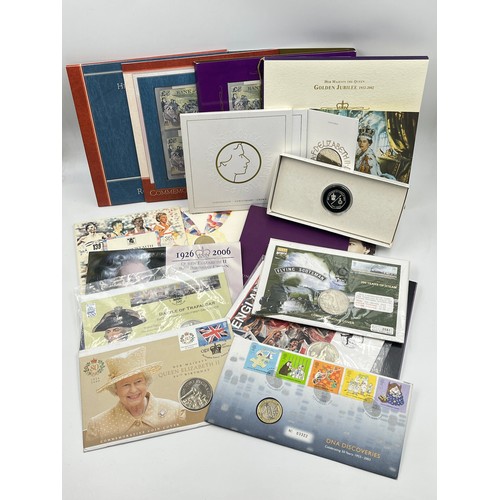 2379 - A collection of packaged coins and banknotes to include 2004, 2005, 2006 £5 first day coin covers, 9... 